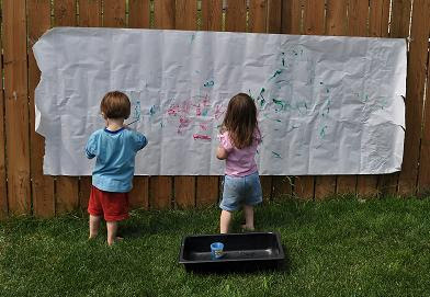 Have kids paint on a large sheet of paper hung onto the fence outside