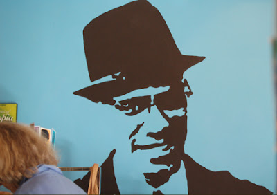 Photo of a stencil of Malcolm X inside Gorilla Cafe