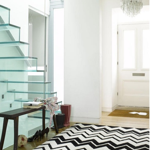 White bright airy hallway glass staircase black and white zig zag pattered rug front door L etc 09/2007 pub orig