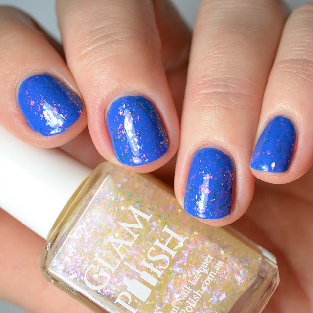 rainbow flakie nail polish swatched over blue