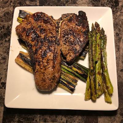 Rare grilled Angus porterhouse with grilled leeks and asparagus