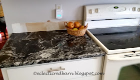 Eclectic Red Barn: black granite counter tops installed beside stove