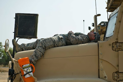Airman rests on his vehicle (Photo by Master Sgt. Jeffrey Allen)