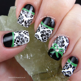 Signature style nail art black and white damask with black half moons and bright green detail, topped with a bow and a crystal.