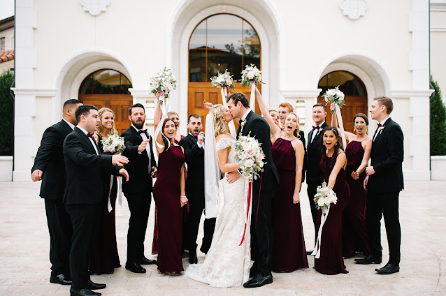 bride and groom with wedding party celebrate