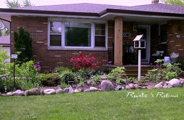 Using large rock to border a rustic garden