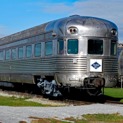 Streamlined stainless-steel passenger car ca. 1930s. A small white sign on front has a blue diamond-shaped area with the words "Reading Lines" in white lettering.