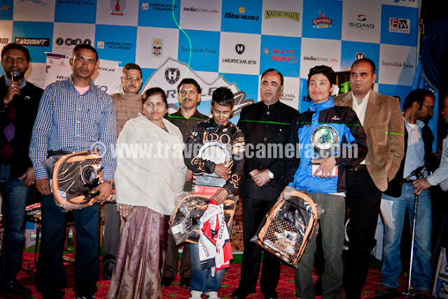 With fun filled 8 days journey of MTB Himachal ended at Shimla Ridge on 8th October, 2011 !! There was prize distribution function on Ridge ground during evening and a grand party in Ritz after that. Let's have a quick PHOTO JOURNEY of the last evening on MTB  Himachal 2011 !!!Here comes the very first photograph of all the Marshals and Volunteers, who are real executors of MTB Himachal 2011. Although this photograph was clicked during the end of prize distribution ceremony, but it's one of the important one and fits well for top photograph of this Photo Journey.Here we have all the winners in various categories. Mohit Sood on mic and Dhananjay on other end. State Minister Narender Baragata was Chief Guest in this ceremony and he handed over few of the main prizes of MTB Himachal 2011 !!Boon and M. Atri also joined in from right side... There were different categories in MTB Himachal 2011 - Master's Category, Team Competition and Champion trophy etc.Various delegates from T1 cycles, Himachal Tourism and other sponsorship companies were present during this final ceremony of MTB Himachal 2011. This ceremony takes place on top of Indira market near Ridge Ground of Shimla, Himachal Pradesh.After Prize distribution ceremony, Mr. Narender Baragata talking to media folks on Ridge ground, Shimla. Mr. Rohit Sharma with Camera on right side. He has been with MTB Himachal rally for 8 days and relayed three full episodes in Shimla Doordarshan & Sports channel.Mr. Narender Baragata expressed his views about cycling and importance of such event in Himachal Pradesh. At the same time he assured that Himachal Pradesh Government will ensure safe and successful events in future. Although most of these events are run by private organization, but Himachali politicians are very well involved in most of them...It was a long press conference on Ridge Ground of Shimla. All press folks as well as Himachal Pradesh ministers were seemed interesting in conversation about MTB Himachal 2011 !!!Here is Mr. Dutta Patil, who was runner in masters category. He belongs to Maharashtra and he has been riding bare feet for last 16 years. In fact he has not used footwear for last 16 years or so. If someone ask him why, his reply is like - I never a need... Can you imagine?Two girl winners of MTB Himachal 2011, having a photograph with VIP guests of final ceremony on Ridge ground of Shimla, Capital city of Himachal Pradesh.Here comes another set of energetic people, who are called as Marshals and Volunteers of MTB Himachal 2011. The real executor of this event. People who have worked hard after compromising many things during 8 days of MTB Himachal 2011.Their enthusiasm and passion was commendable. Hope HASTPA would have appreciated their efforts with some tokens on same day. Alas it didn't happen this year. In 2010, they were very well appreciated with appropriate tokens and certificates. Hope they will got some tokens after completion of this event...VIP Guests sitting on front row on Ridge Ground, where MTB Final ceremony took place...Political talks with nice laughter :) ... Mr. Suresh Bhardwaj and Mr. Narender Baragata !!With this MTB Himachal Pradesh 2011 completed and now it was time for Party. I preferred not to click any photographs in Party as event was over and it was time to enjoy :) ... Now on to MTB Himachal Pradesh 2012 !!! Let's see how things work out... 