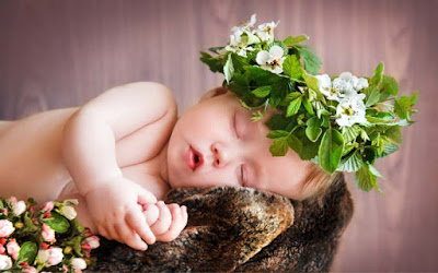 sleeping-soft-silkybaby-wearing-flower-croftan-on-head