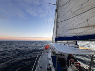 sailing vessel at sunset on open sea