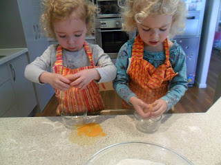 Cracking eggs into a dish for rainbow cake.