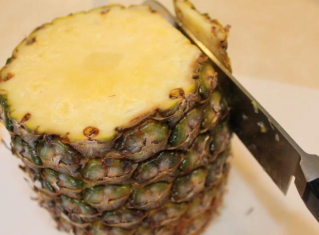 The Second Step in Preparing a Fresh Pineapple is to Slice the Skin.