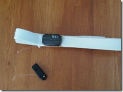 Black piece on the white band is the BAHA unit. The other Black piece is a clip to keep unit from falling to the floor should the band come loose