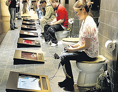 Visitors playing Playstation while sitting on toilet seats