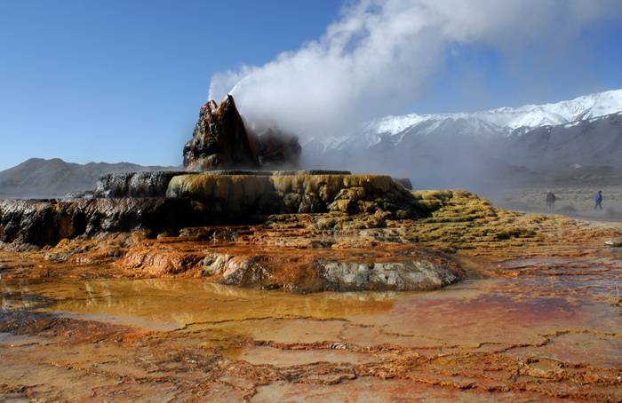 Fly Geyser is a little-known tourist attraction, even to Nevada residents. It is located near the edge of Fly Reservoir and is only about 5 feet (1.5 m) high, (12 feet (3.7 m) counting the mound on which it sits). The Geyser is not an entirely natural phenomenon, and was accidentally created in 1916 during well drilling. The well functioned normally for several decades, but in the 1960s geothermally heated water found a weak spot in the wall and began escaping to the surface. Dissolved minerals started rising and accumulating, creating the mount on which the geyser sits, which continues growing. Today water is constantly spewing, reaching 5 feet (1.5 m) in the air. The geyser contains several terraces discharging water into 30 to 40 pools over an area of 30 hectares (74 acres). The geyser is made up of a series of different minerals, which gives it its magnificent coloration.