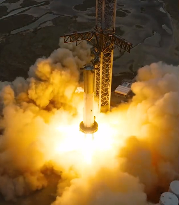 An aerial shot of Starship's Super Heavy Booster 7 firing 31 of its 33 Raptor 2 engines during a test at Starbase, Texas...on February 9, 2023.