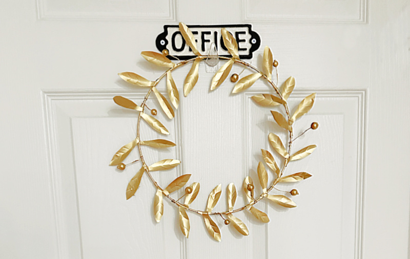 gold metal wreath on door