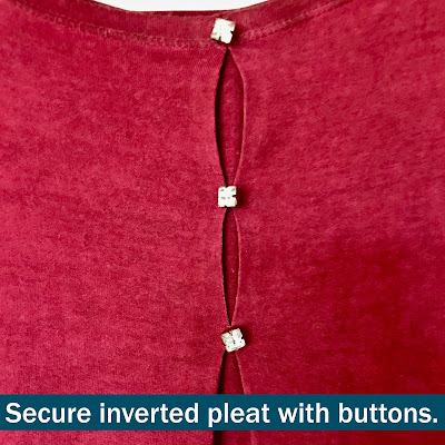 Picture of red top with buttons securing inverted pleat.