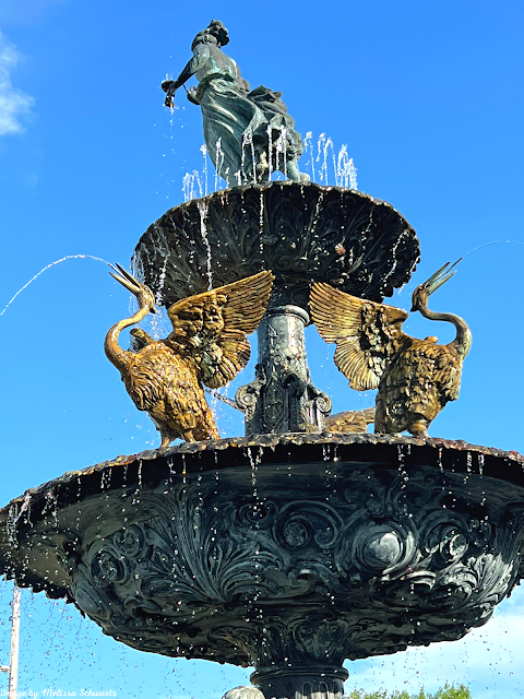 The Renaissance Fountain with Cranes captivates in the summer sun.