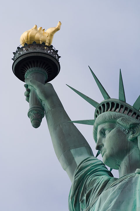 statue of liberty torch hand. From her beacon-hand Glows