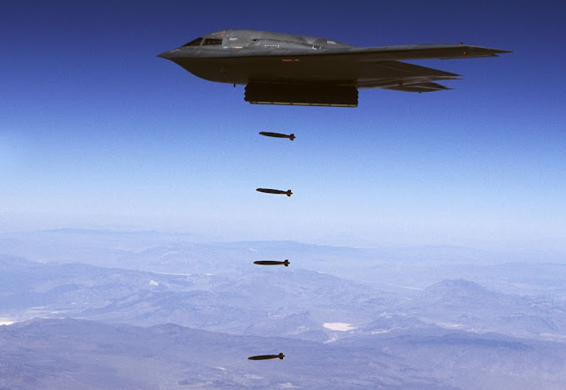 A B-2 Spirit drops 32 inert Joint Direct Attack bombs.