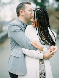 engaged couple outside hugging