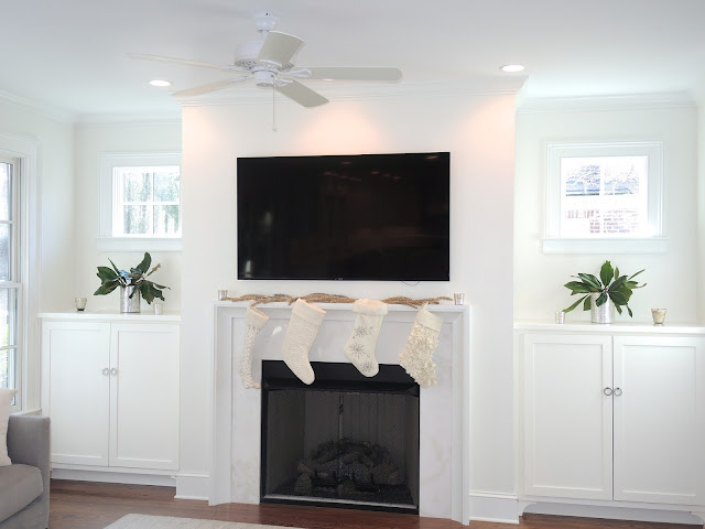 transitional built ins cabinets windows above simple molding mantle