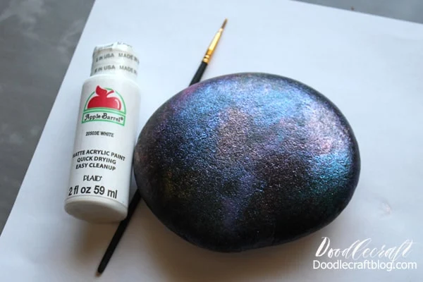 Painting a galaxy with stars and planets and the moon on a rock with hand lettered text diy instructions