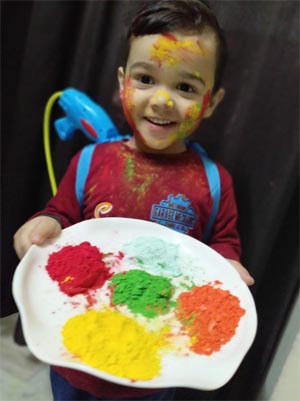 A student celebrating Holi