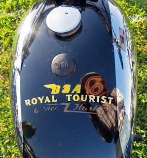 Tank of motorcycle is labelled Royal Tourist.