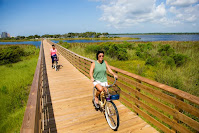 Gulf State Park visitors biking on park trail