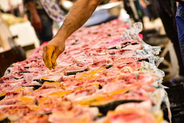 Butchery section with a butcher processing fresh meat