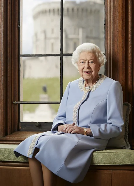 Queen Elizabeth wore a soft dove blue coat and dress, both designed by Angela Kelly