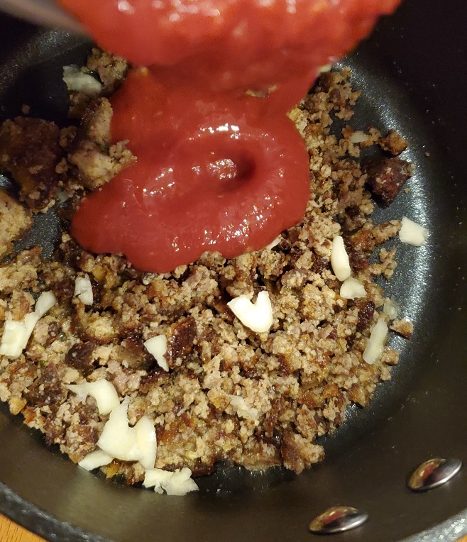 cooked ground beef with onions and garlic with tomato sauce for tacos