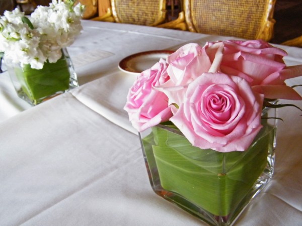 Simple vases of Roses Hydrangea Stock and Orchids lined the long dinner 