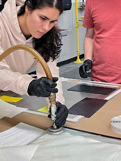 A UofU student attaches industrial vacuum