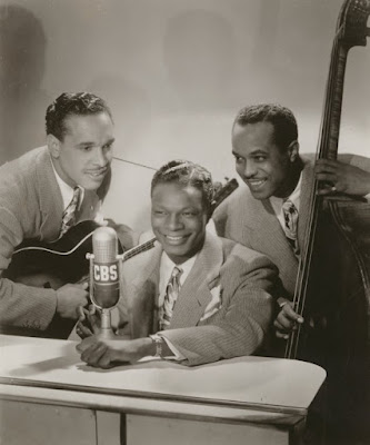 Nat King Cole with two other musicians