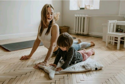 A woman exercising with her kid