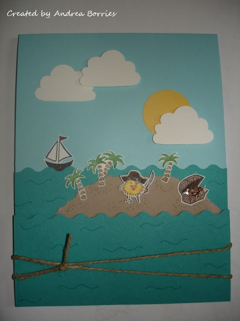 Light blue card with layered teal card stock scalloped like waves. A light brown island has stamped and cut-out palm trees, pirate chickie and treasure chest (with glitter treasure). There is also a sailing boat, clouds and sun.