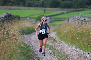 Me smiling running up a stony hill path.