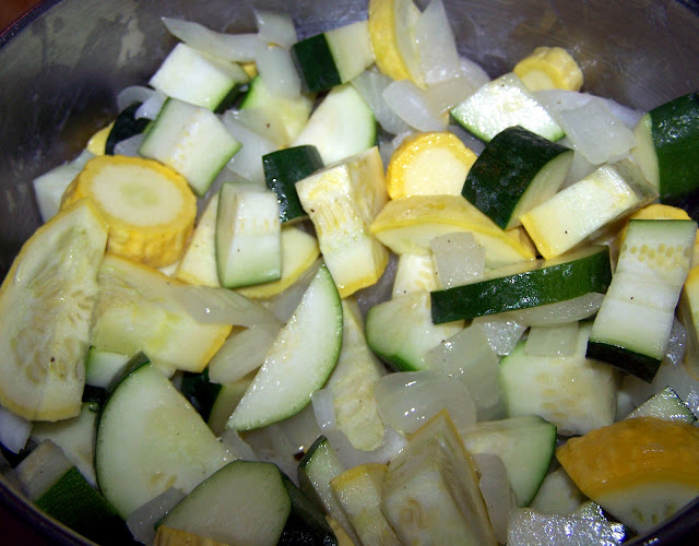 Cooking chopped zucchini and squash in onions