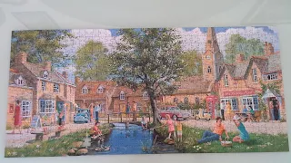 A finished jigsaw puzzle of a riverside country village in rural england. It took some putting together!