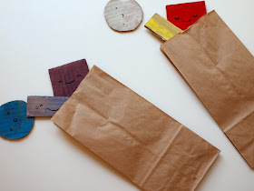 place your shapes into brown paper bags