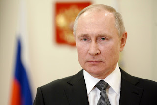 Vladimir Putin signs legislation authorizing him to serve two more terms as Russia's president.