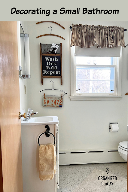 Photo of a small bathroom decorated with vintage clothes hangers and other vintage collectibles.