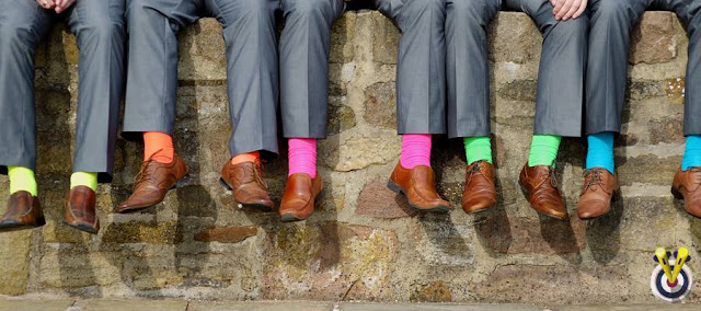 Best Man & Ushers Sat On A Wall with bright socks on