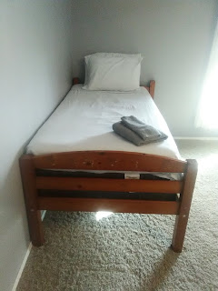 The tidy and cozy twin bed at The Village bed and breakfast.