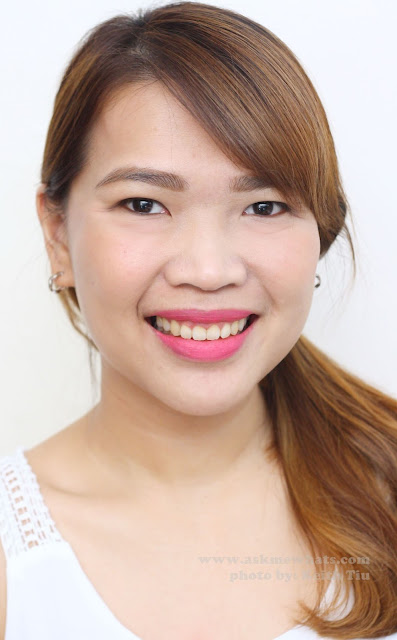 A photo of a girl wearing  Sleek True Colour Lipsticks in Pink Freeze