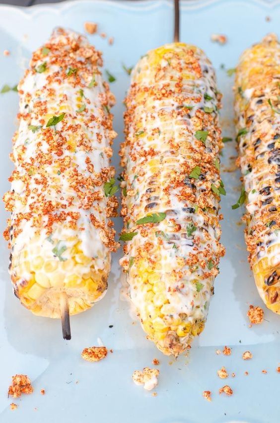 Mexican Street Corn - Mexican style corn on the cob smeared with a creamy spread and sprinkled with a cheesy spiced topping. Perfect for summer grilling. via @seededtable