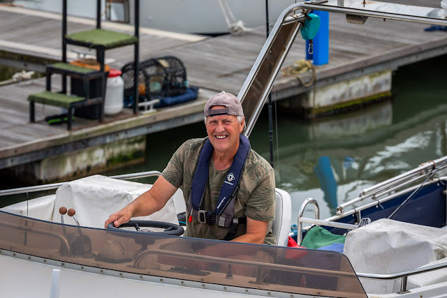 Photo of Phil at the helm on Ravensdale's flybridge. Photo by Ronnie Bell